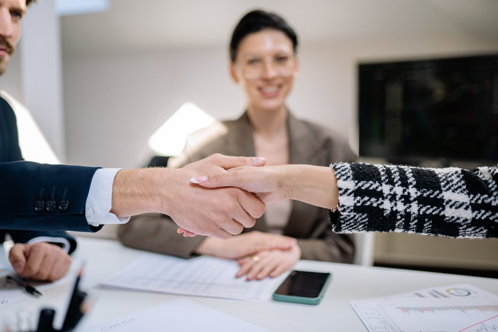 Business handshake sealing an agreement, representing understanding commercial lease key terms