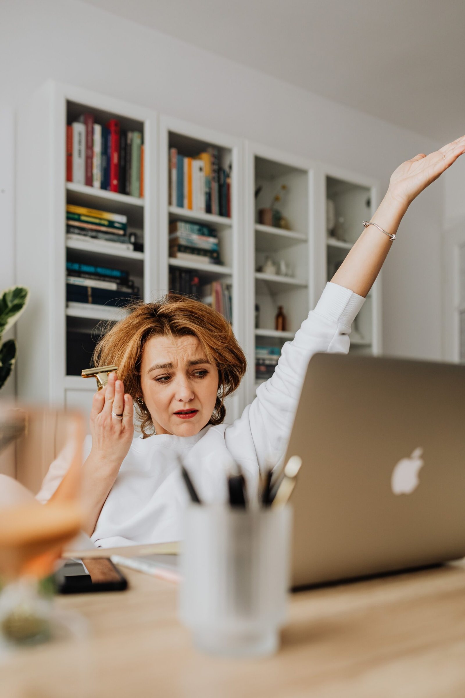 Confused woman looking at her laptop in an office, representing common onboarding mistakes
