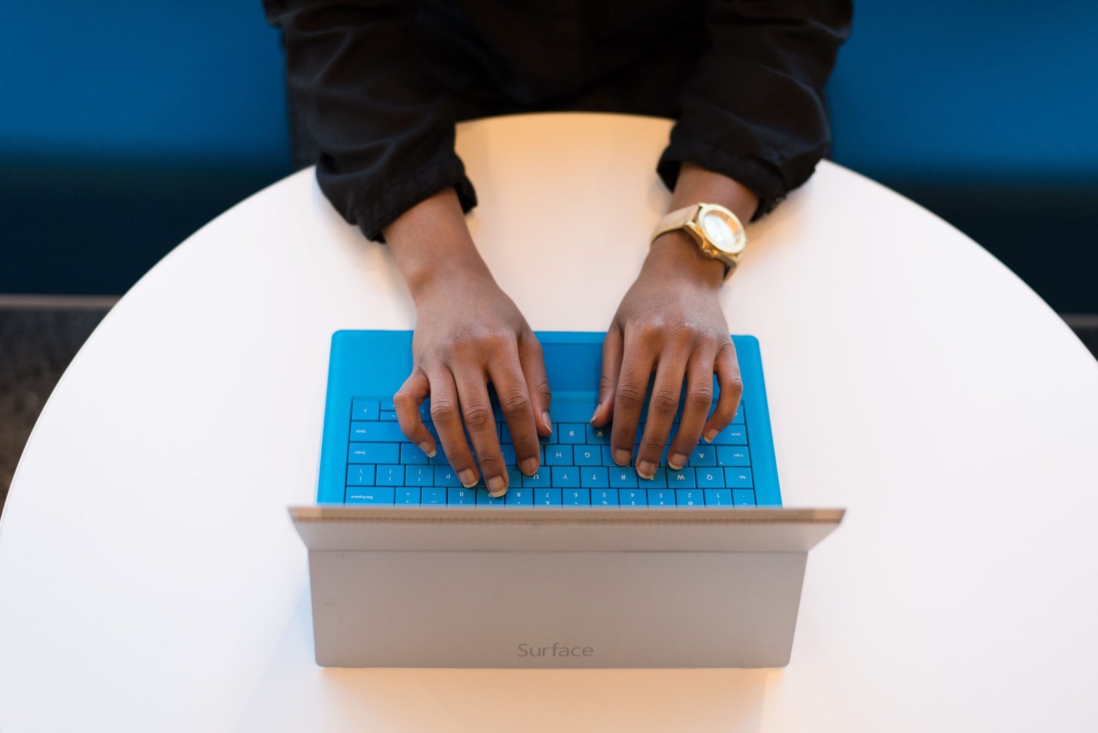 Person typing on a laptop keyboard, representing cyber security basics for a small business