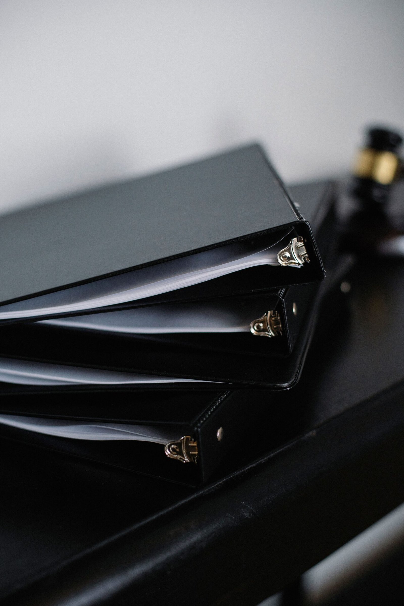 Stacked office binders and folders representing essential HR policies for a small business