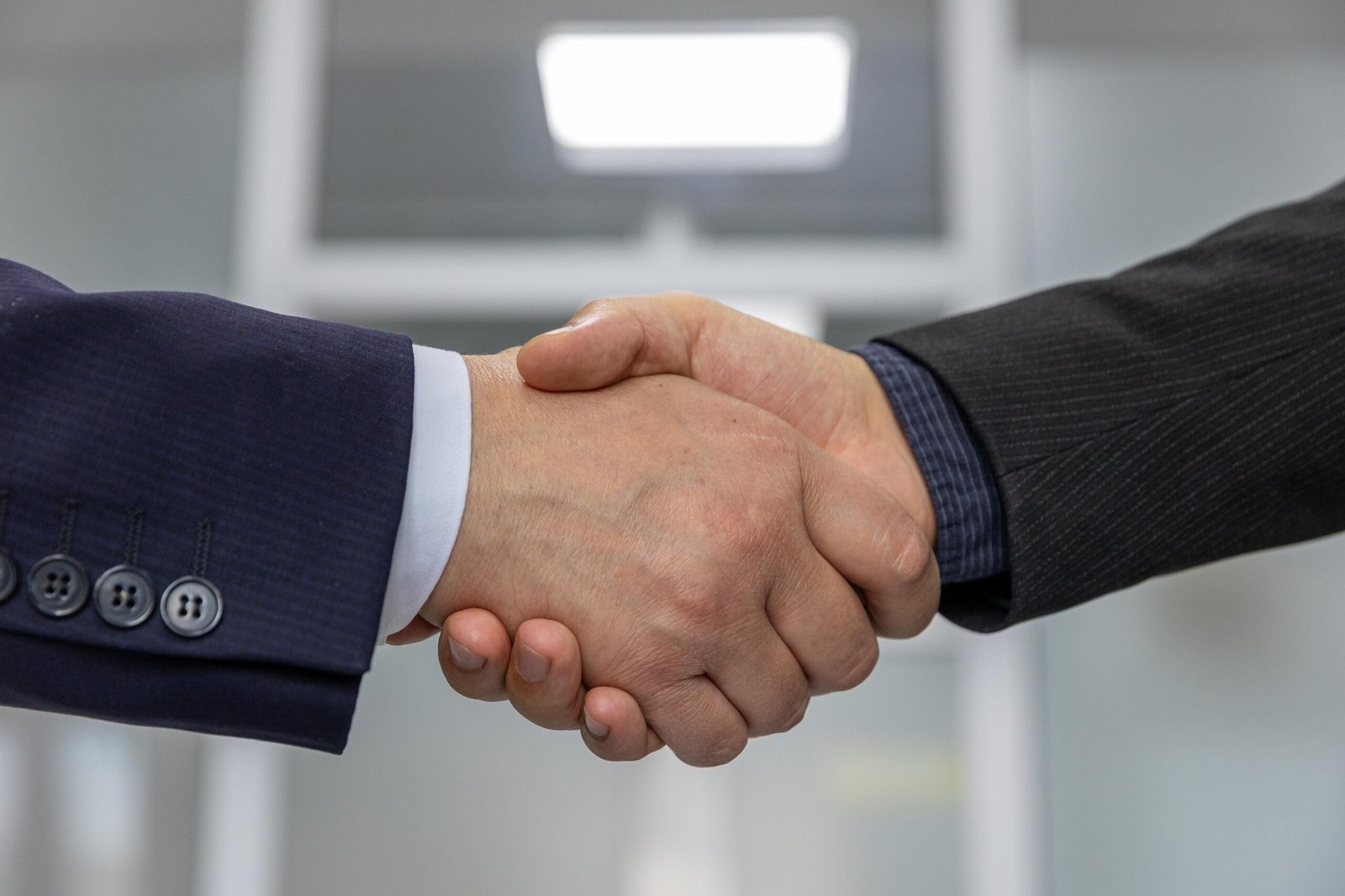 Close-up of a business handshake sealing an exclusivity agreement between a supplier and a business