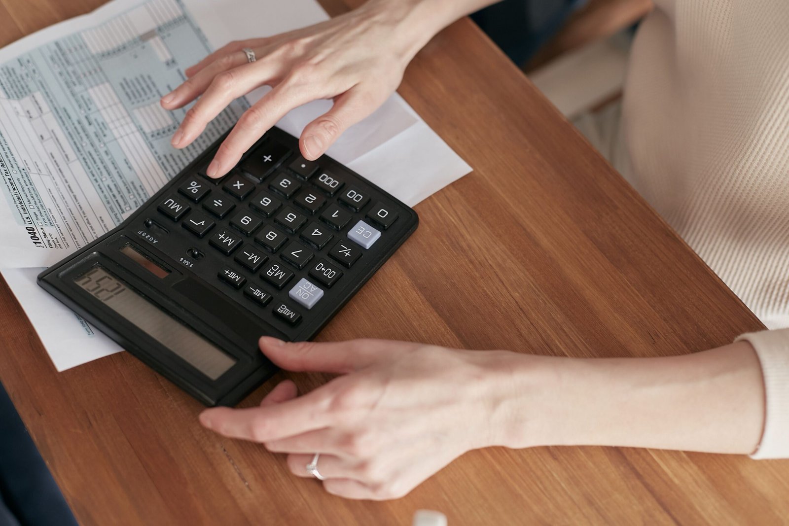 Person writing a formal letter at a desk, representing properly terminating a supplier contract