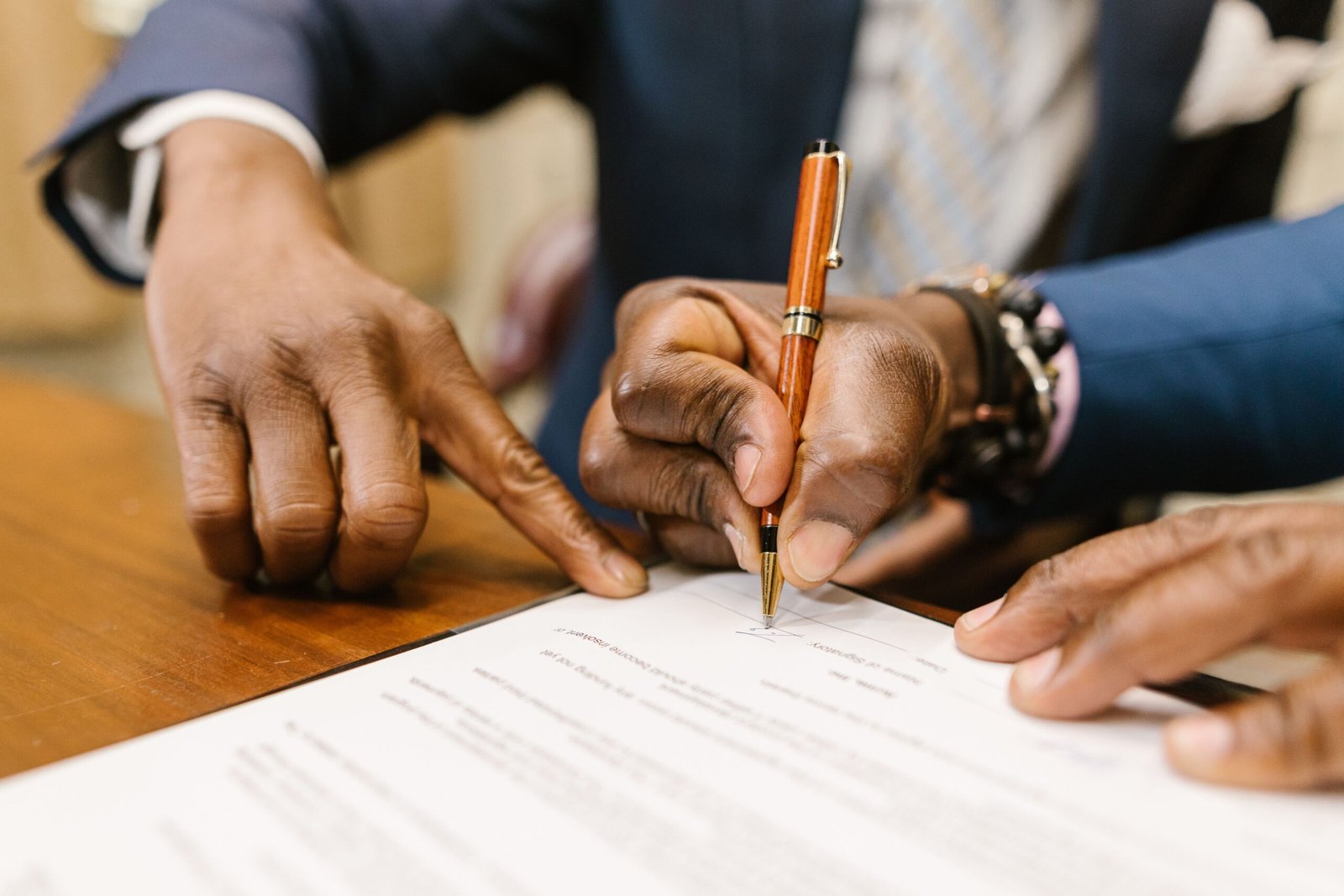 Person signing an employment contract as part of new starter legal compliance