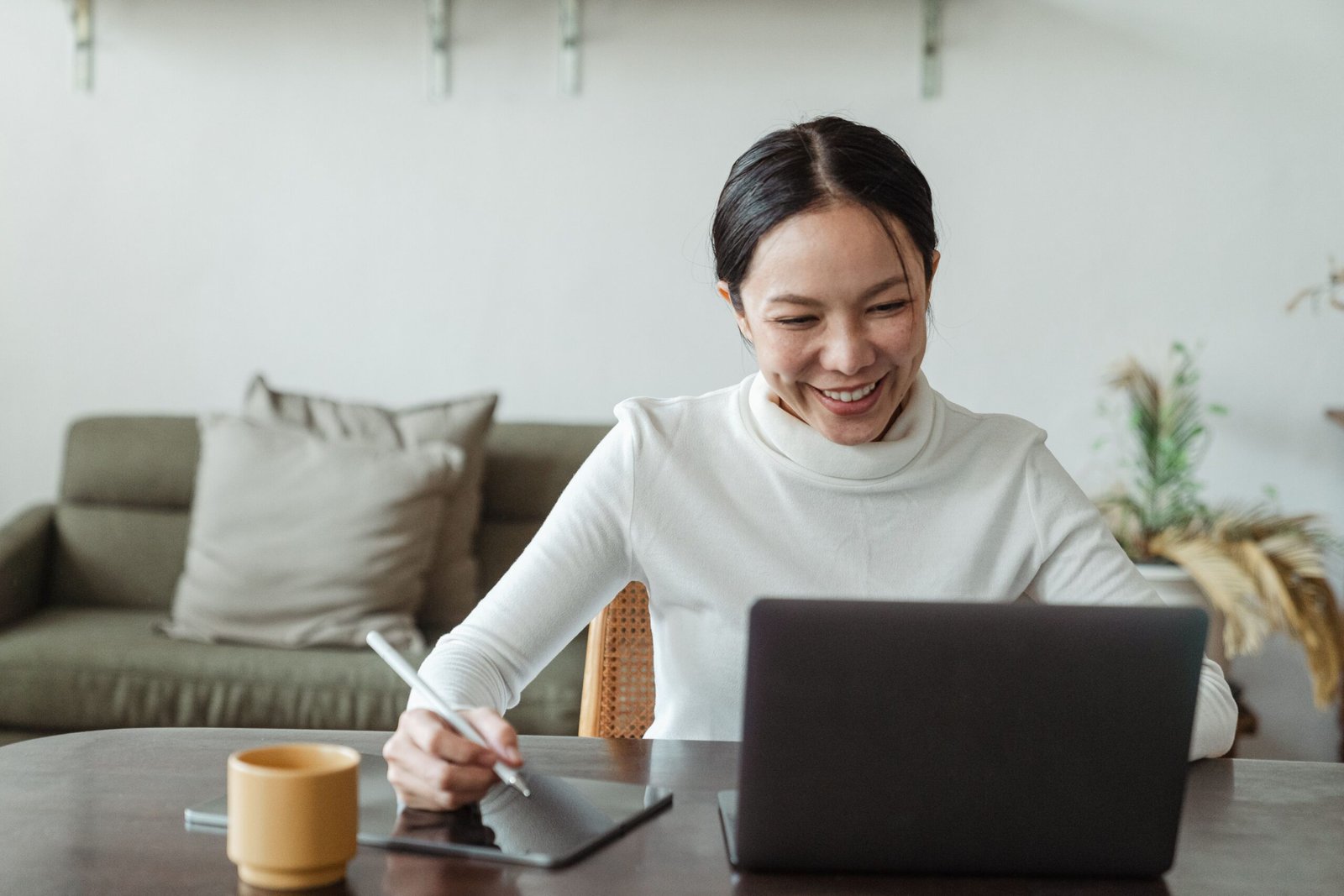 Woman on a video call with a laptop, representing remote employee onboarding