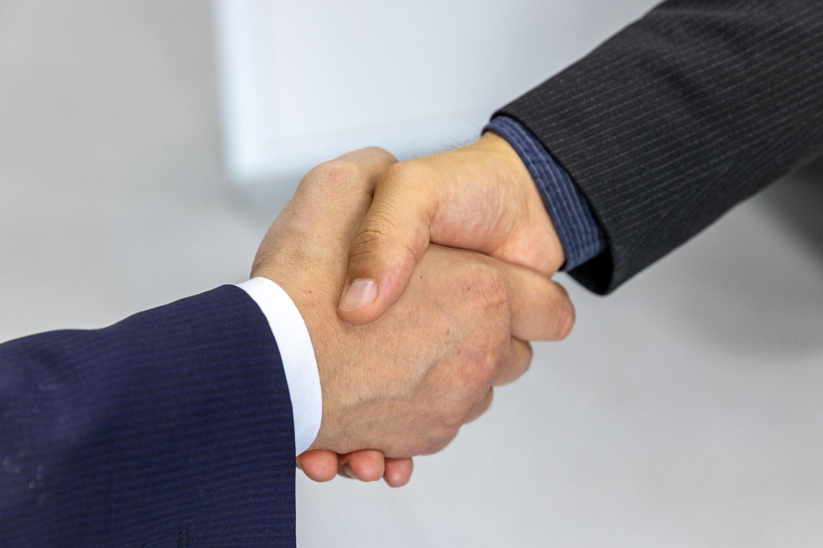 Confident handshake between two business professionals after agreeing on a price increase