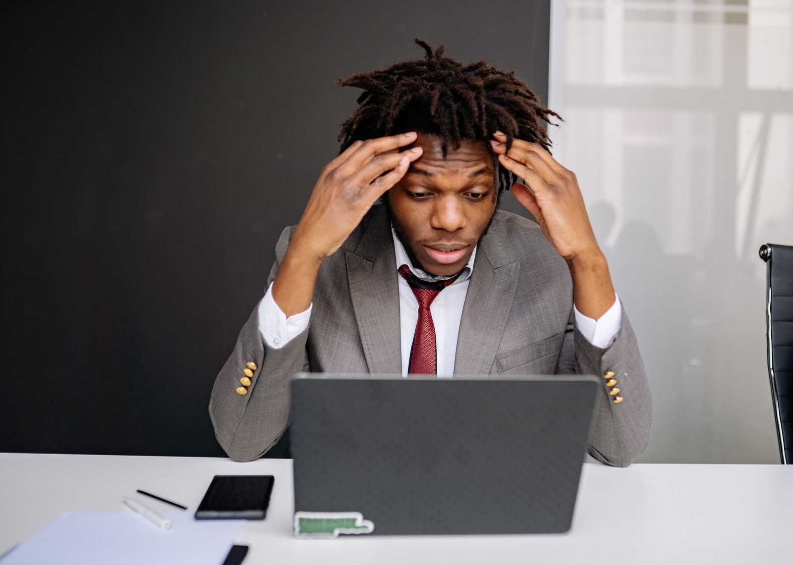 Frustrated business owner working on a laptop, representing common small business pricing mistakes